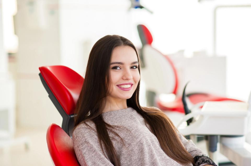 A relaxed patient smiling in a dental chair