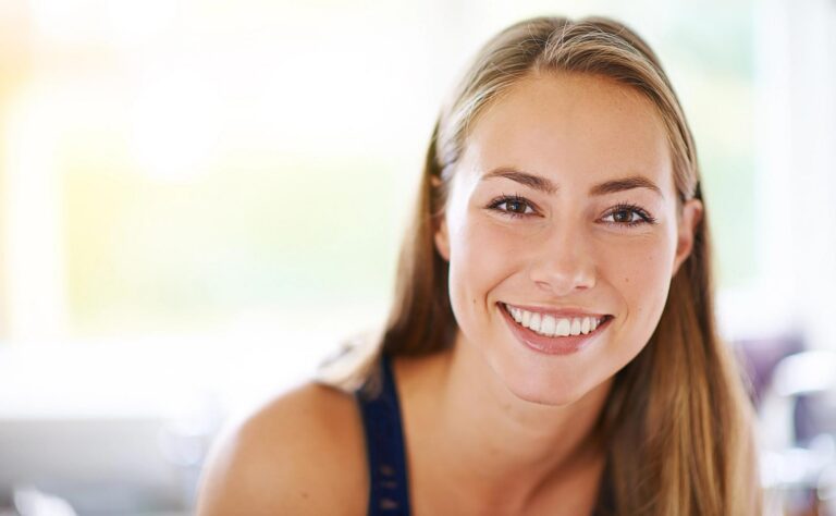 A young woman with long blonde hair smiling at the camera.
