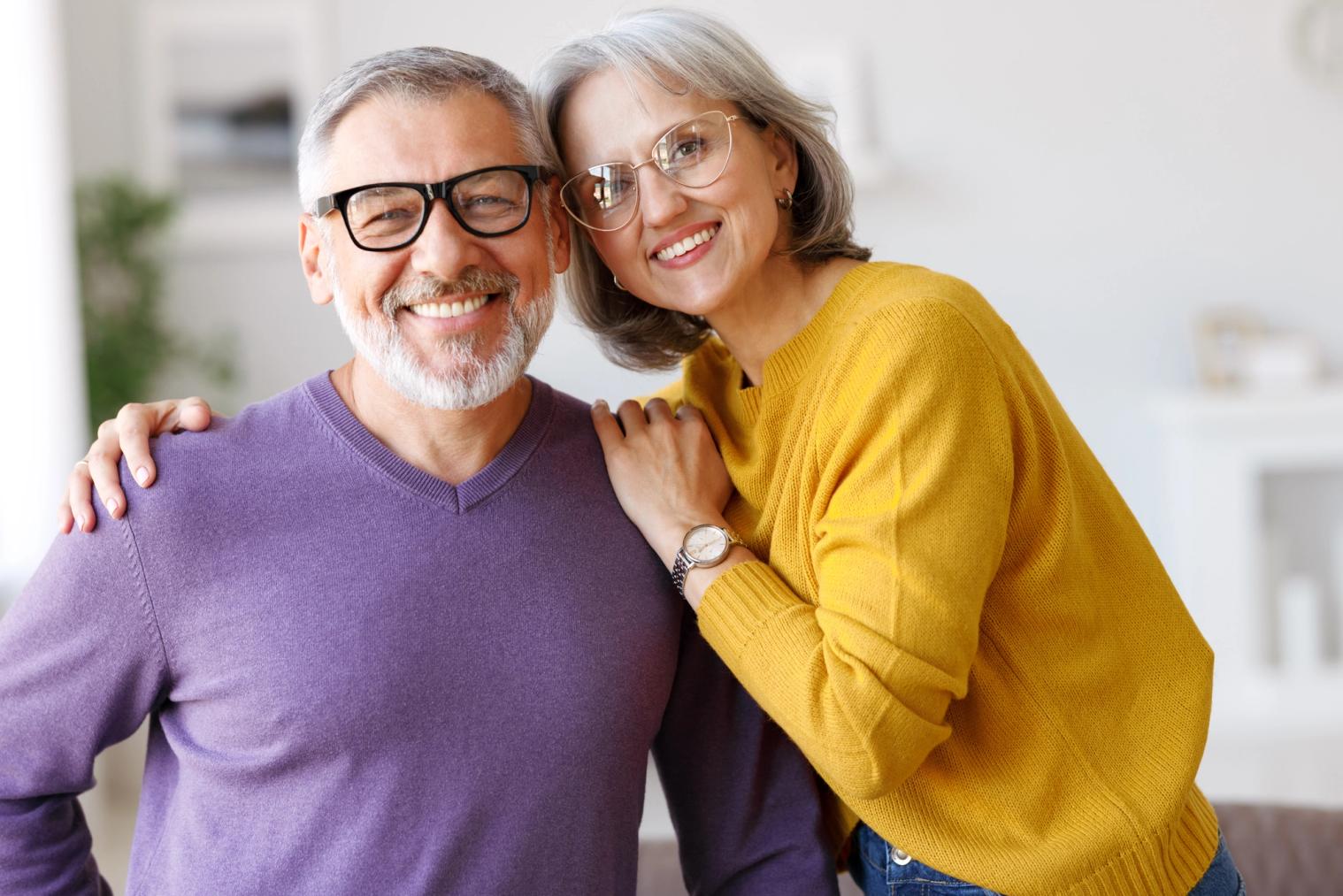 An older couple smiling at the camera.